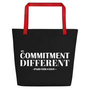 Front view of the black My Commitment Different WAJ Large Tote Bag with red handle. 