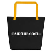 Front view of the black Paid The Cost Large Tote Bag with yellow handle.