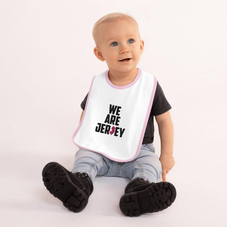 We Are Jersey Baby Bib mock up with a pink outline.
