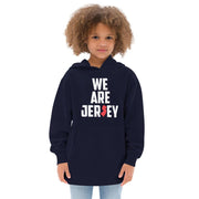 Female child wearing the navy blue We Are Jersey Kids Hoodie. 